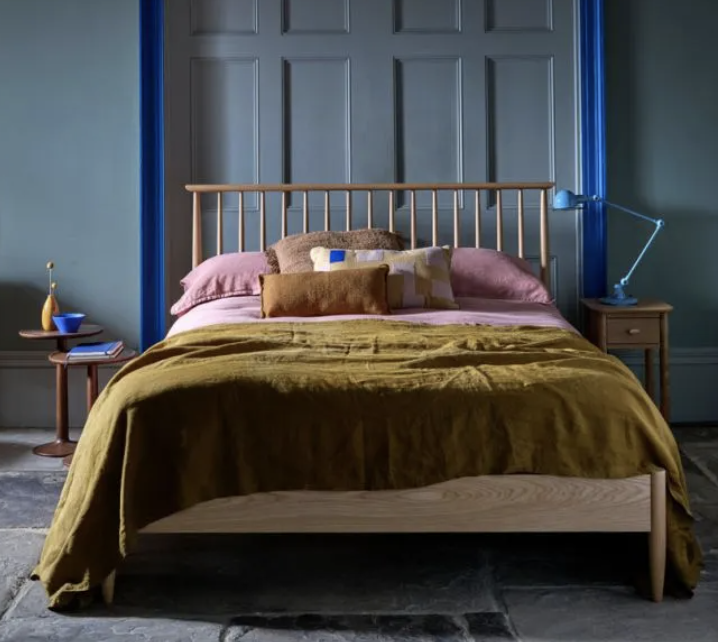 wooden bed with wooden slats as a headboard