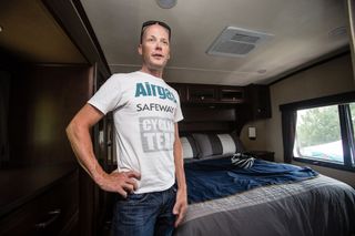 Chris Horner stands in the bedroom of the RV he takes to races.