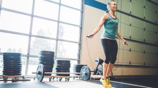 Mature woman skipping rope in gym