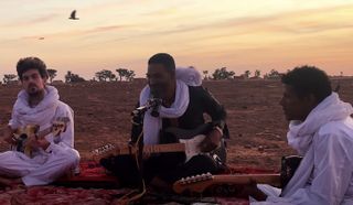 Mdou Moctar and his band perform on the banks of the Niger river