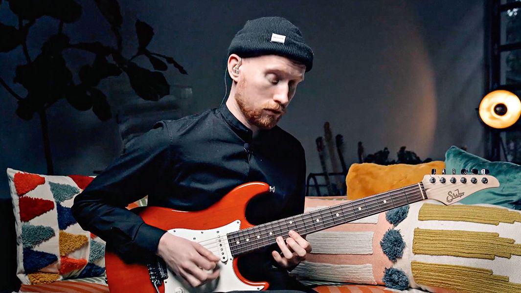 Niklas Myhre plays a Suhr electric guitar