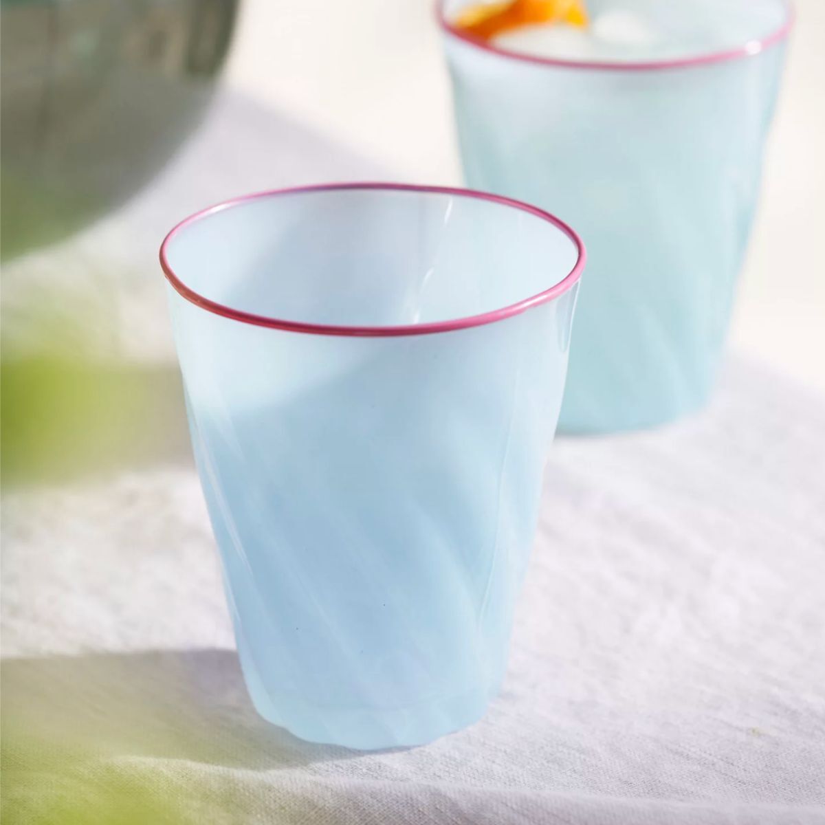 Blue drinking glasses with a pink rim
