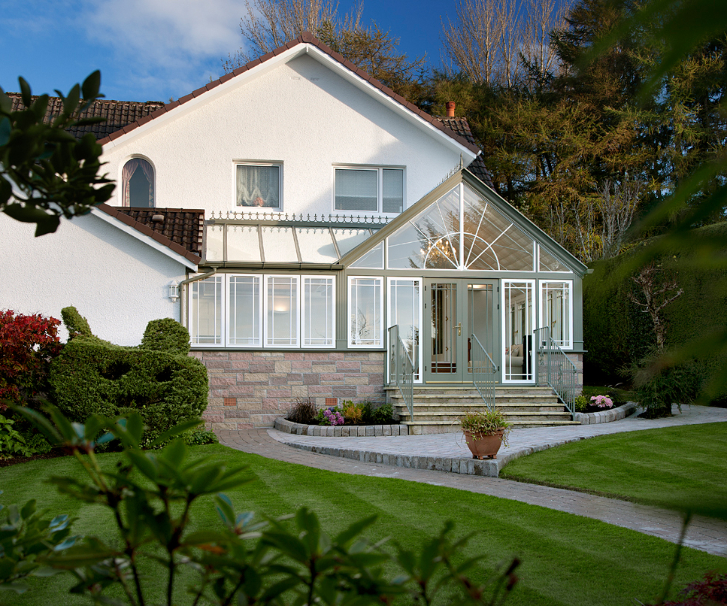 white house with conservatory matching house elevation