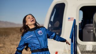 Emily Calandrelli celebrates in front of the Blue Origin capsule after becoming the 100th woman in space. 