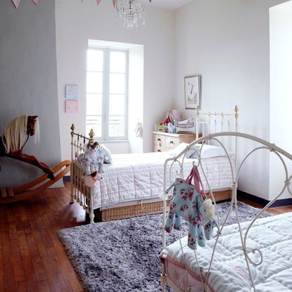 bedroom with plush carpet and wooden flooring