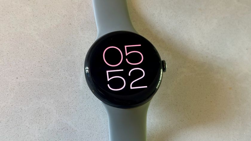 The Google Pixel Watch 3 on a white counter, showing the Big Time watch face.