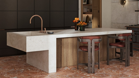 kitchen island that is half marble half wood in the centre of the room. The floor is a red marble.