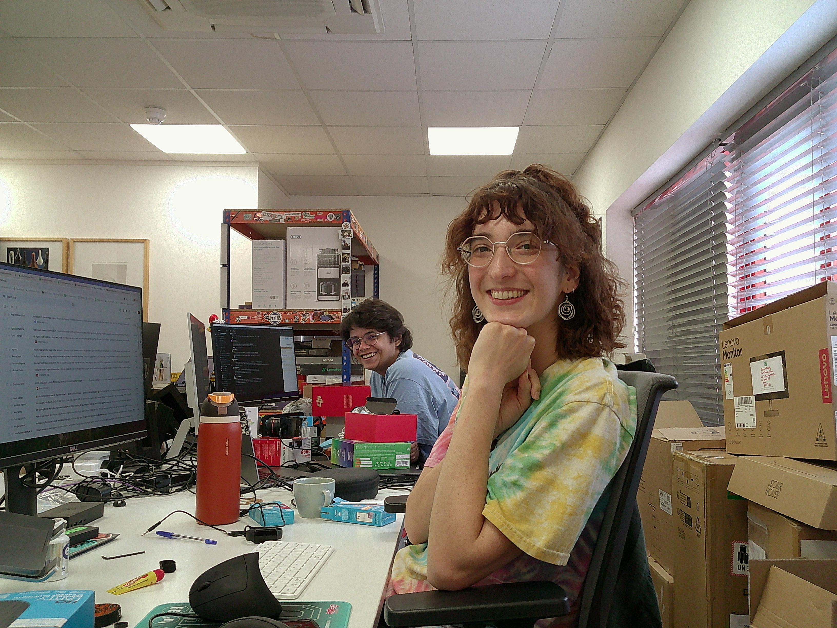 two women sat in an office at their desks
