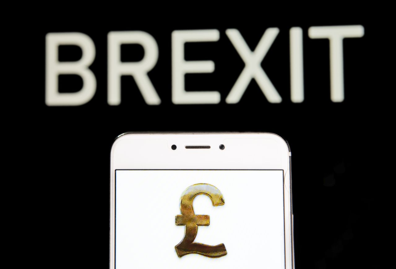 HONG KONG - 2019/04/20: In this photo illustration a Great Britain&amp;#039;s currency Pound Sterling icon is seen on an Android mobile device with a Brexit message in the background. (Photo Illustrat