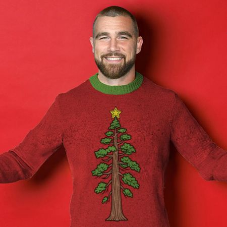 Travis Kelce wearing a Christmas sweater referencing Taylor Swift's song "Wood." 