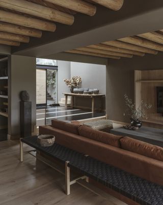 A living room with natural light and wooden beams