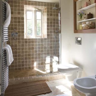 bathroom with commode and shower area