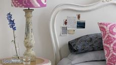 white wall with table lamp and cushions