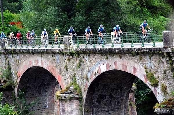 Columbia passes a scenic bridge ahead of the bunch.