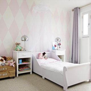bedroom with printed pink wall and white bed