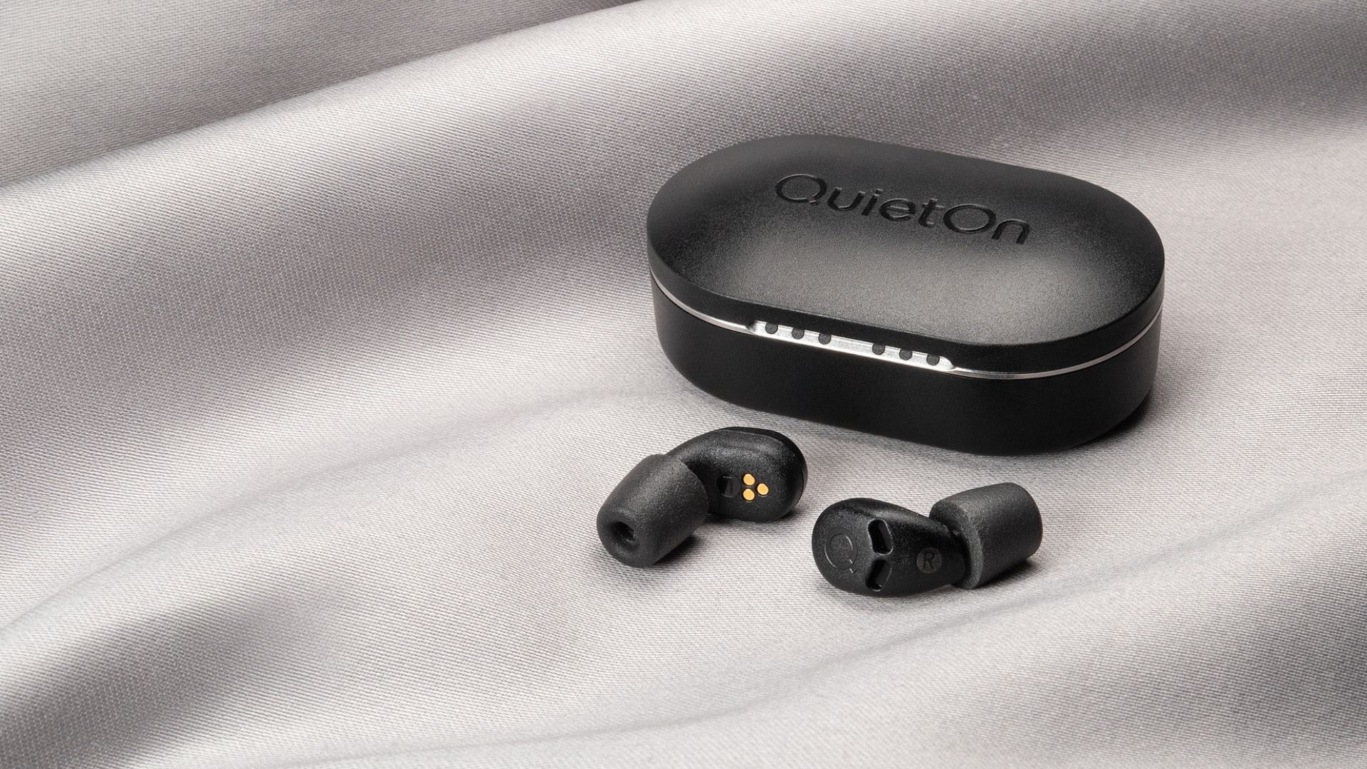 QuietOn 4 Sleep Earbuds on a gray background.