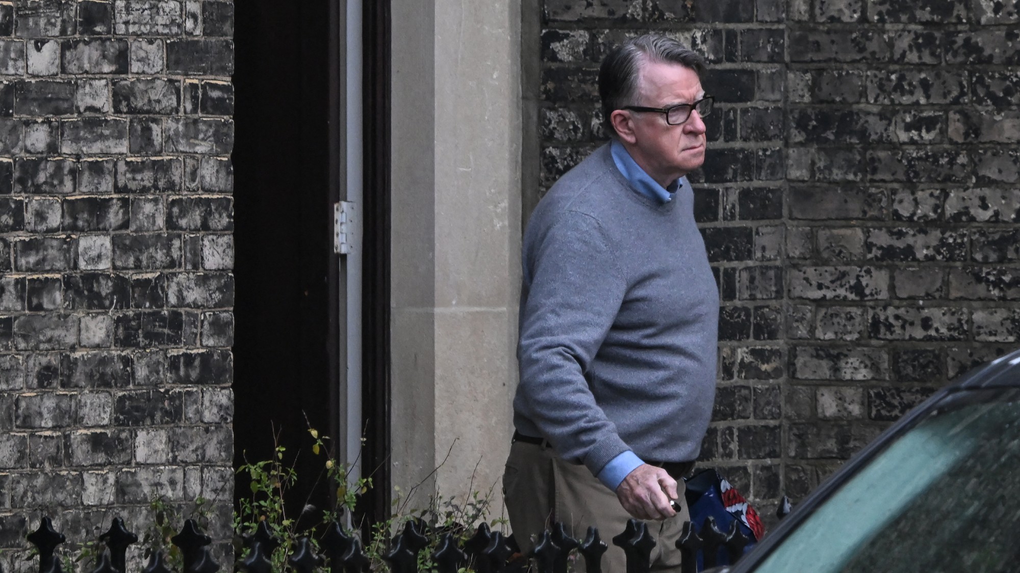 Peter Mandelson leaving a building