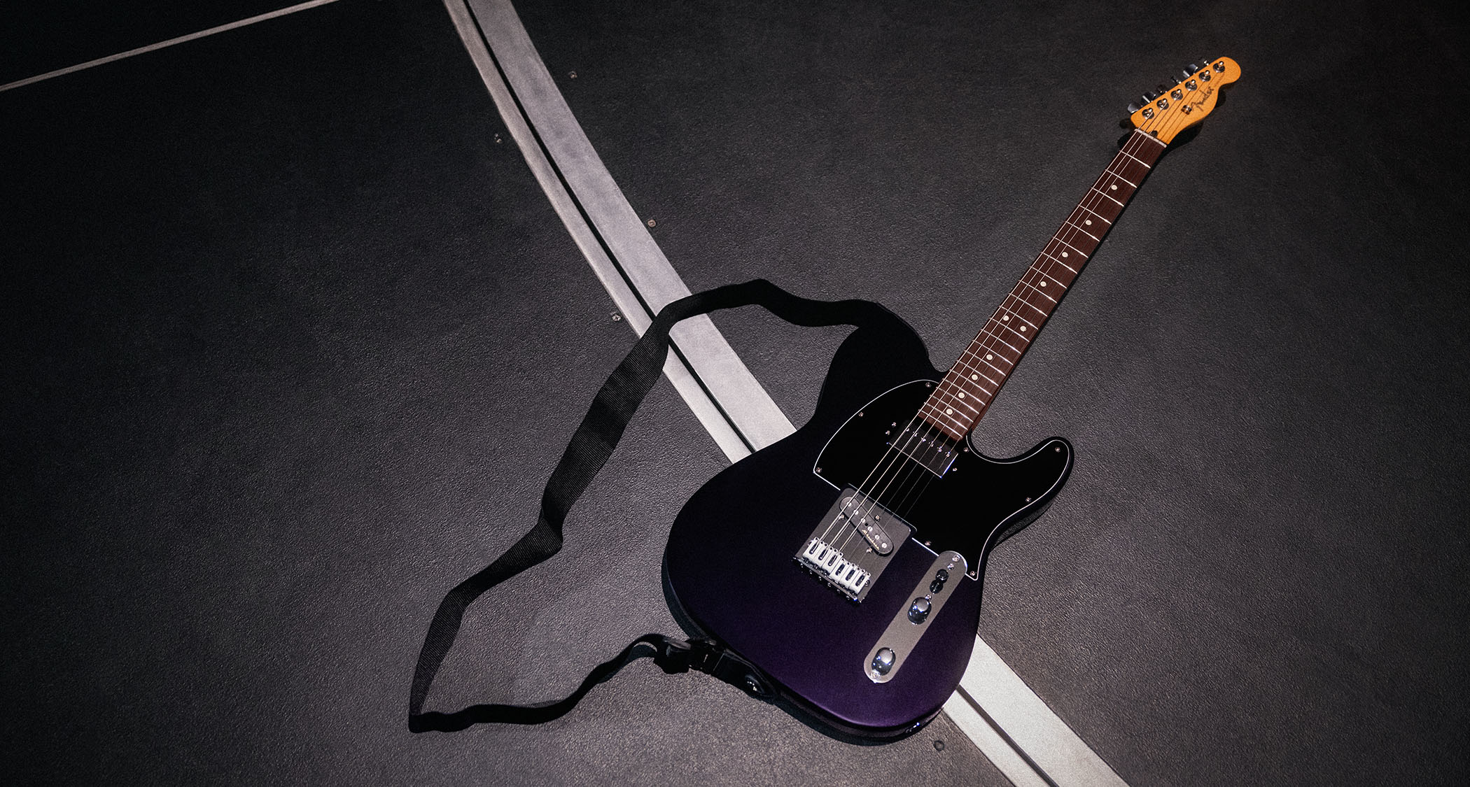 Fender Player II Modified Telecaster SH: the factory-modded, humbucker-equipped Telecaster is finished in Dusk, a dark metallic purple, and is photographed backstage.