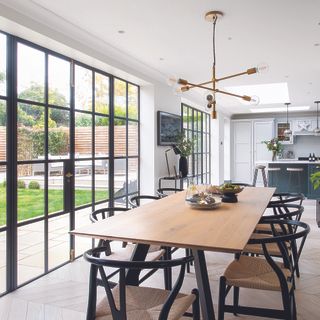 Open plan modern kitchen with table and crittall doors