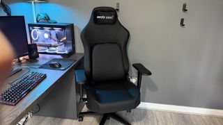 The AndaSeat Phantom 4 Pro in a brightly lit home office environment in front of a gaming PC.