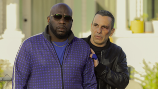 Omar J. Dorsey, wearing sunglasses and a tracksuit, alongside Sebastian Maniscalco, in leather jacket and sporting a black eye, star in new Max drama Bookie.