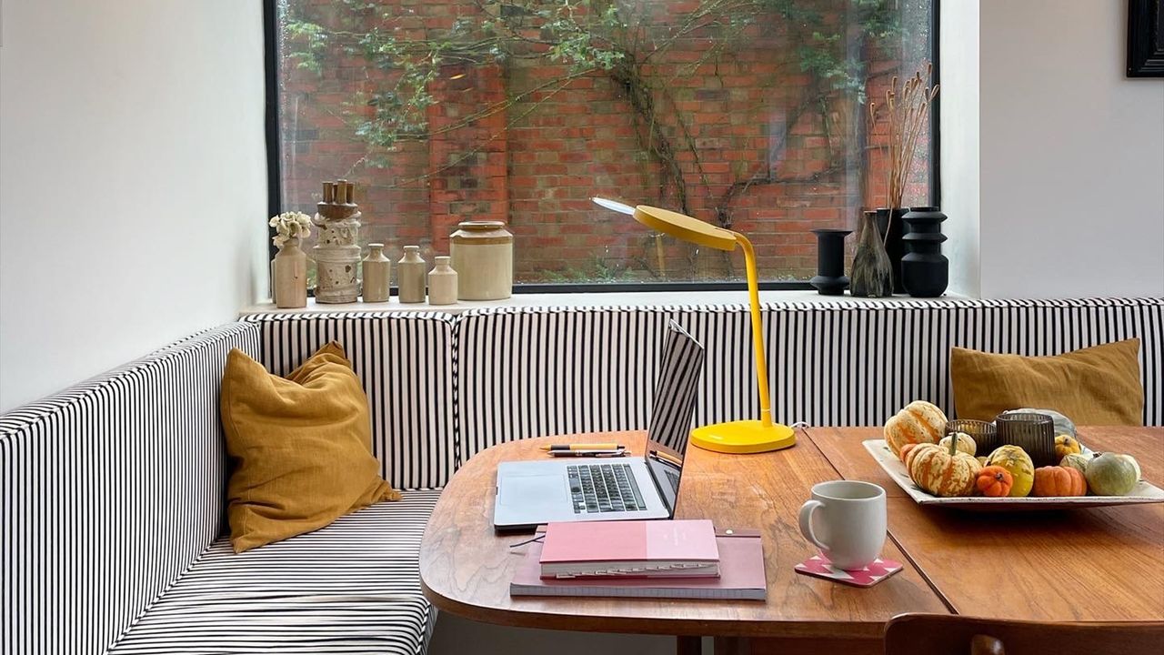 Wfh space on a kitchen table next to a large picture window