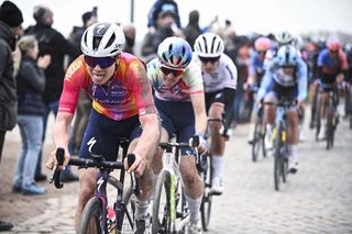 Lotte Kopecky battles on in the chase after a mass crash on the cobbles