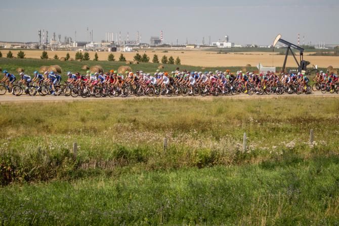 The peloton passes by oil operations as it gets closer to Red Deer.