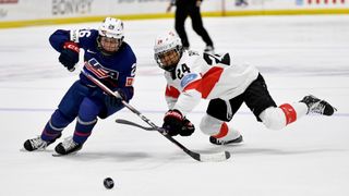 Kendall Coyne Schofield #26 of the United States skates the puck past Noemi Ryhner #24 of Switzerland in the second period during the 2024 IIHF World Championship