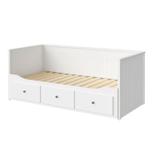 A white wooden day bed with three drawers at the bottom of it