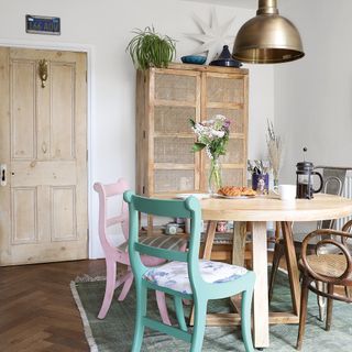 Victorian property revamp dining room open plan with a round table and mismatched chairs