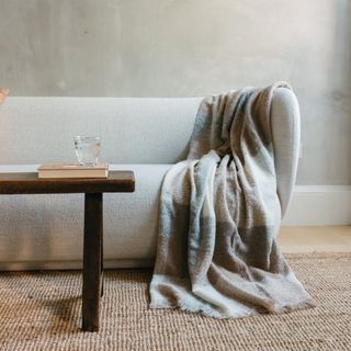 Undyed Alpaca Blanket in Neutral Check draped over sofa