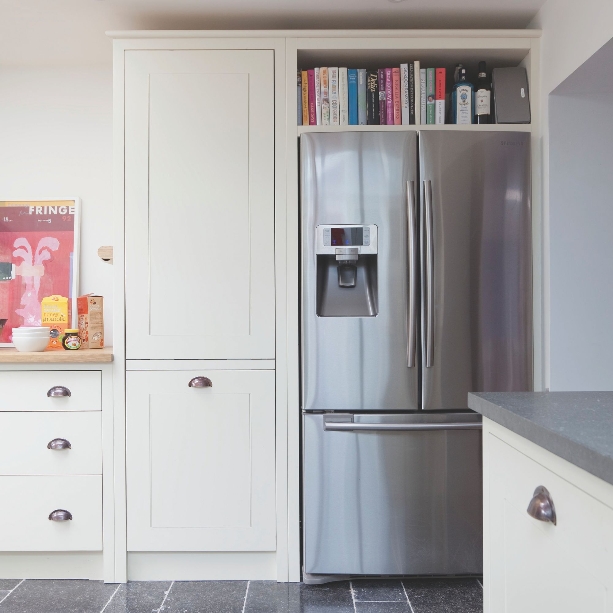 Kitchen with white cabinets and a large silver fridge/freezer