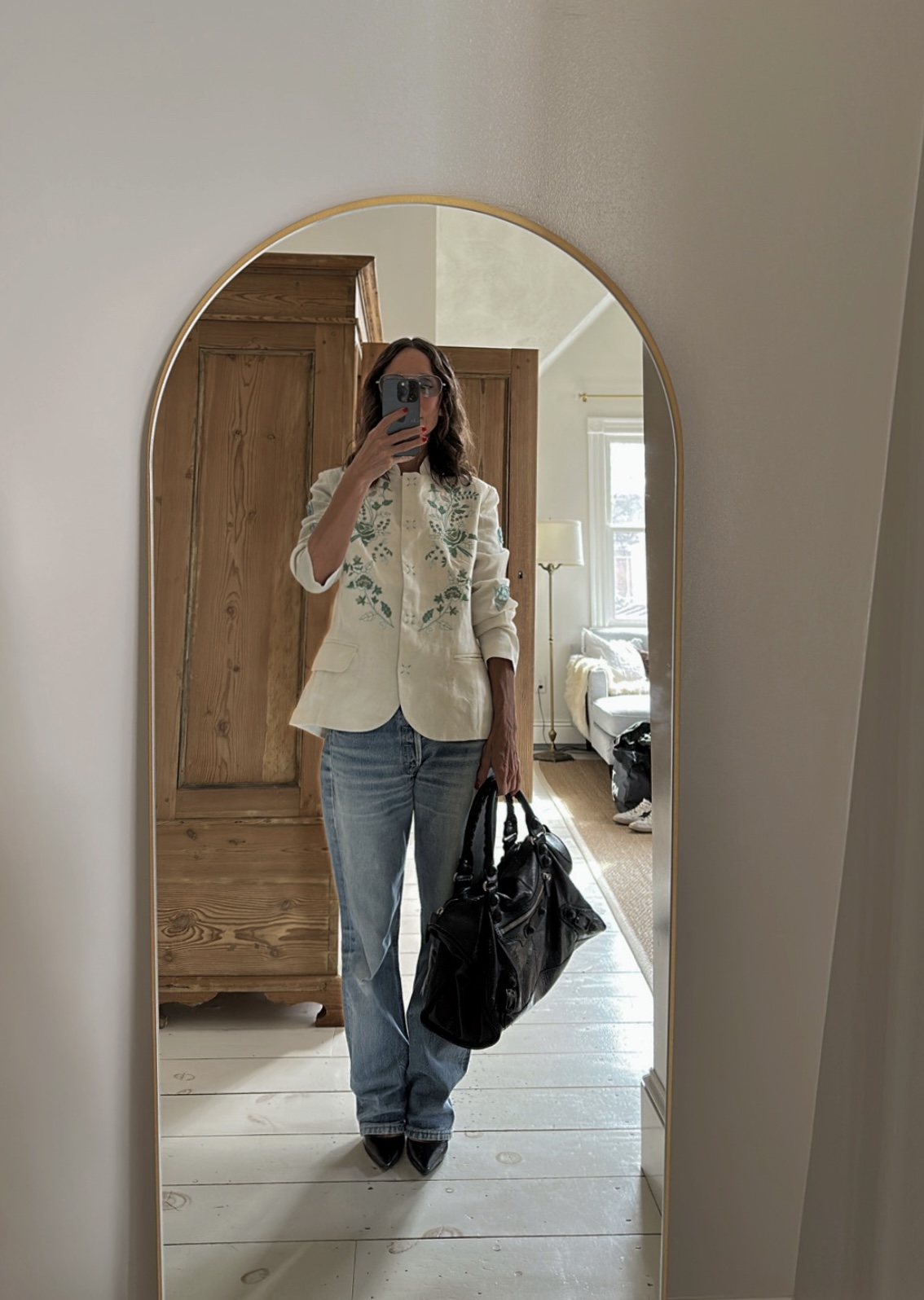 Larissa Mills wearing blue jeans and a white blazer