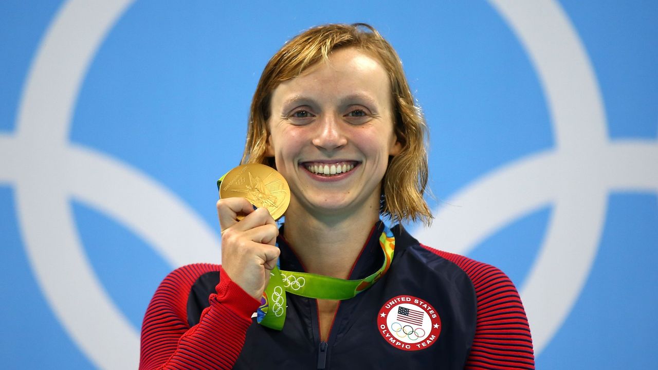 Katie Ledecky of United States celebrates on the podium after winning gold in the Women&#039;s 800m Freestyle Final on Day 7 of the Rio 2016 Olympic Games