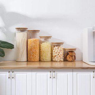 Glass and bamboo jars on kitchen worktop