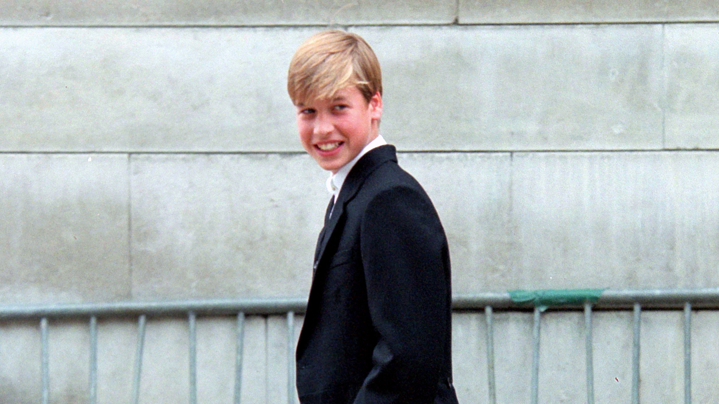 Prince William smiles as he walks at Eton to register at the college and also to check into Manor House