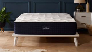 The DreamCloud Luxury Hybrid Mattress on a bed