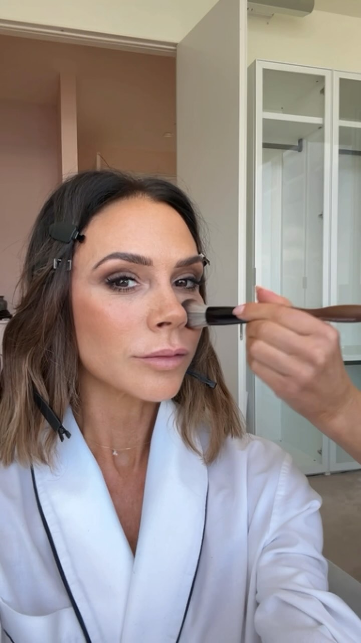 Victoria Beckham having her eye makeup done