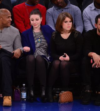 Michelle Trachtenberg and Princess Eugenie sit next to one another at Madison Square Garden on December 14, 2013 to watch the Atlanta Hawks vs New York Knicks