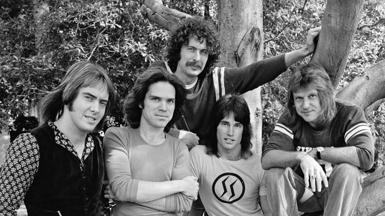 Player standing in front of a tree, 1977