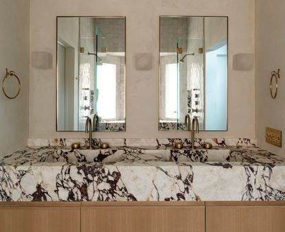 A quiet luxury bathroom with wood, marble and limewash walls