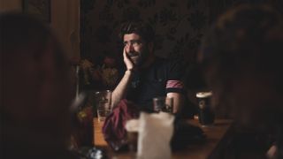 A man sitting in a pub looking out the window