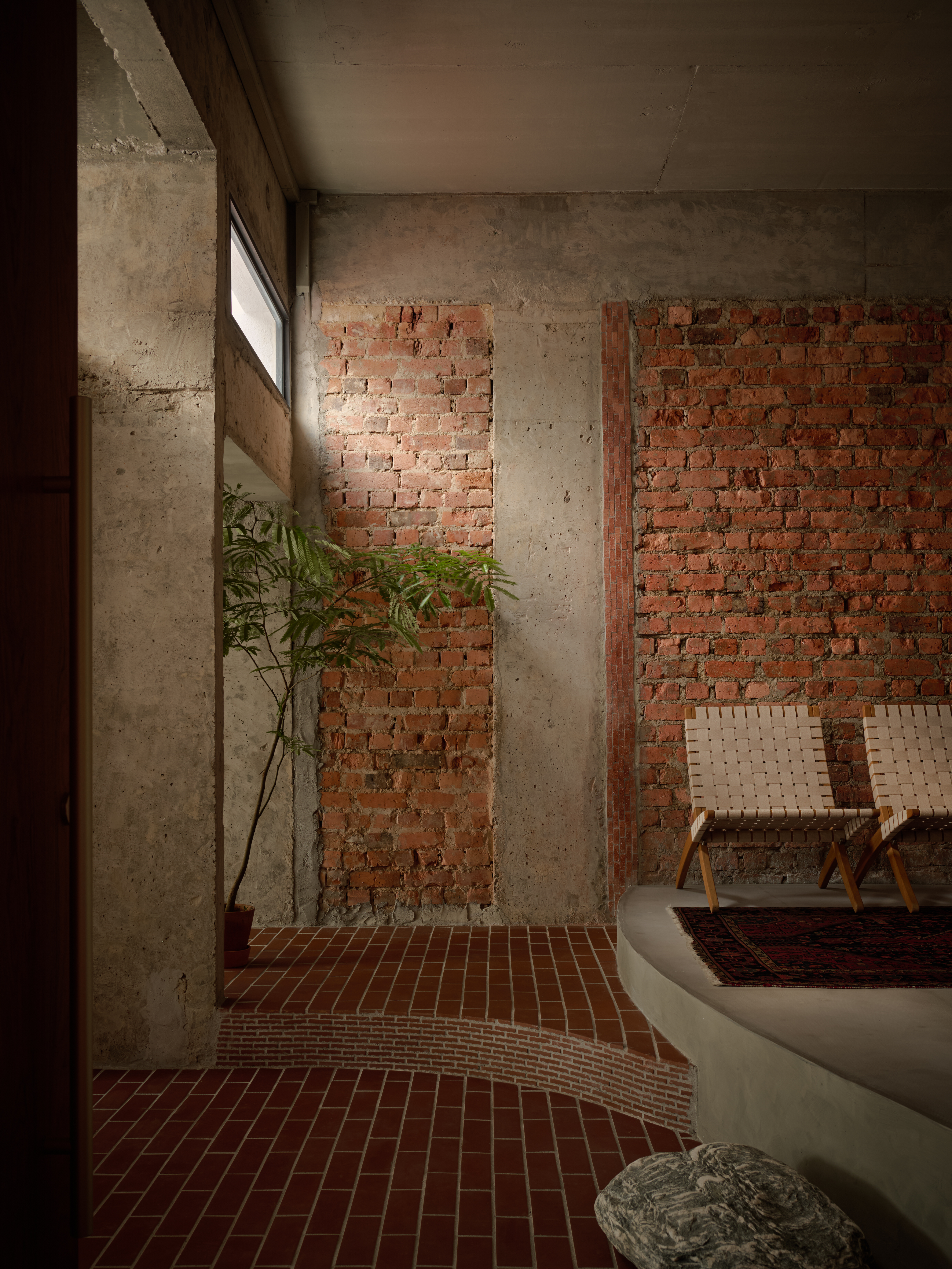 'My last home' by L Architects, a raw interior space of exposed brown brick and wood detailing
