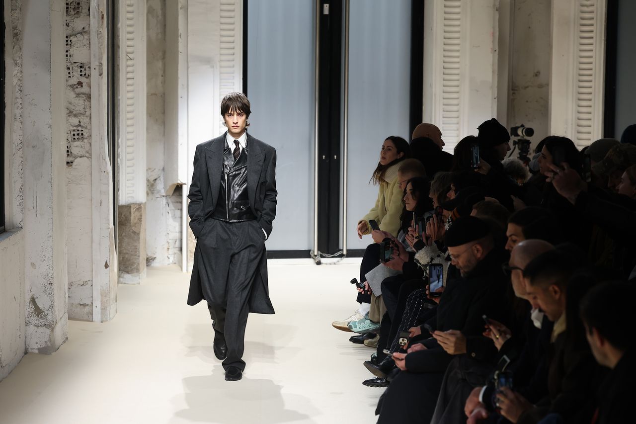 Auralee A/W 2025 menswear show at Paris Fashion Week Men’s A/W 2025 featuring model in coat and trousers on runway