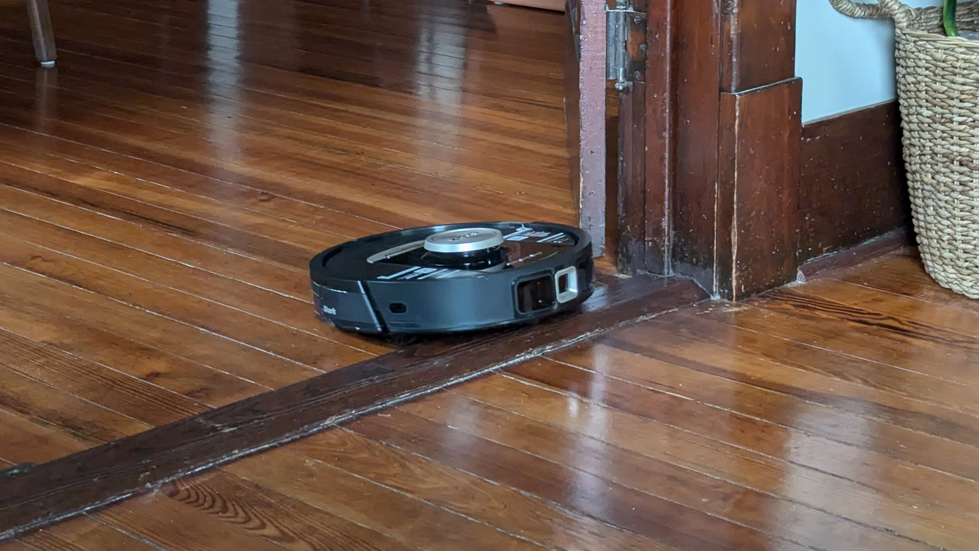 Shark PowerDetect Robot Vacuum and Mop climbing over a raised threshold