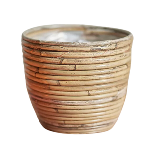 A striped basket planter with rattan weaving