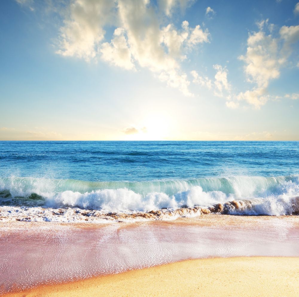 Ocean waves lap the sand on the beach.