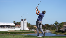 Austin Smotherman hits an approach shot into the green