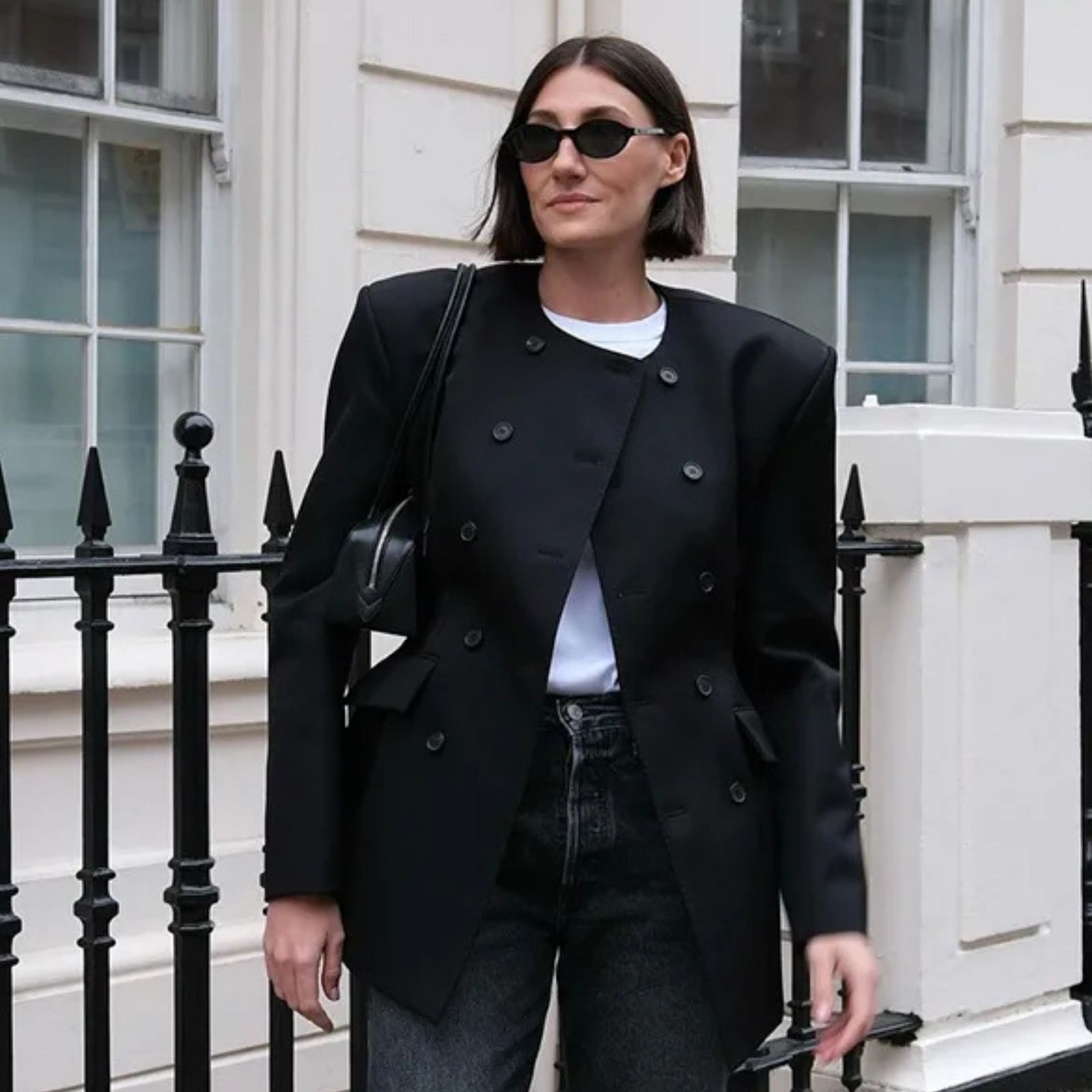 A woman wears skinny jeans with an oversized black blazer